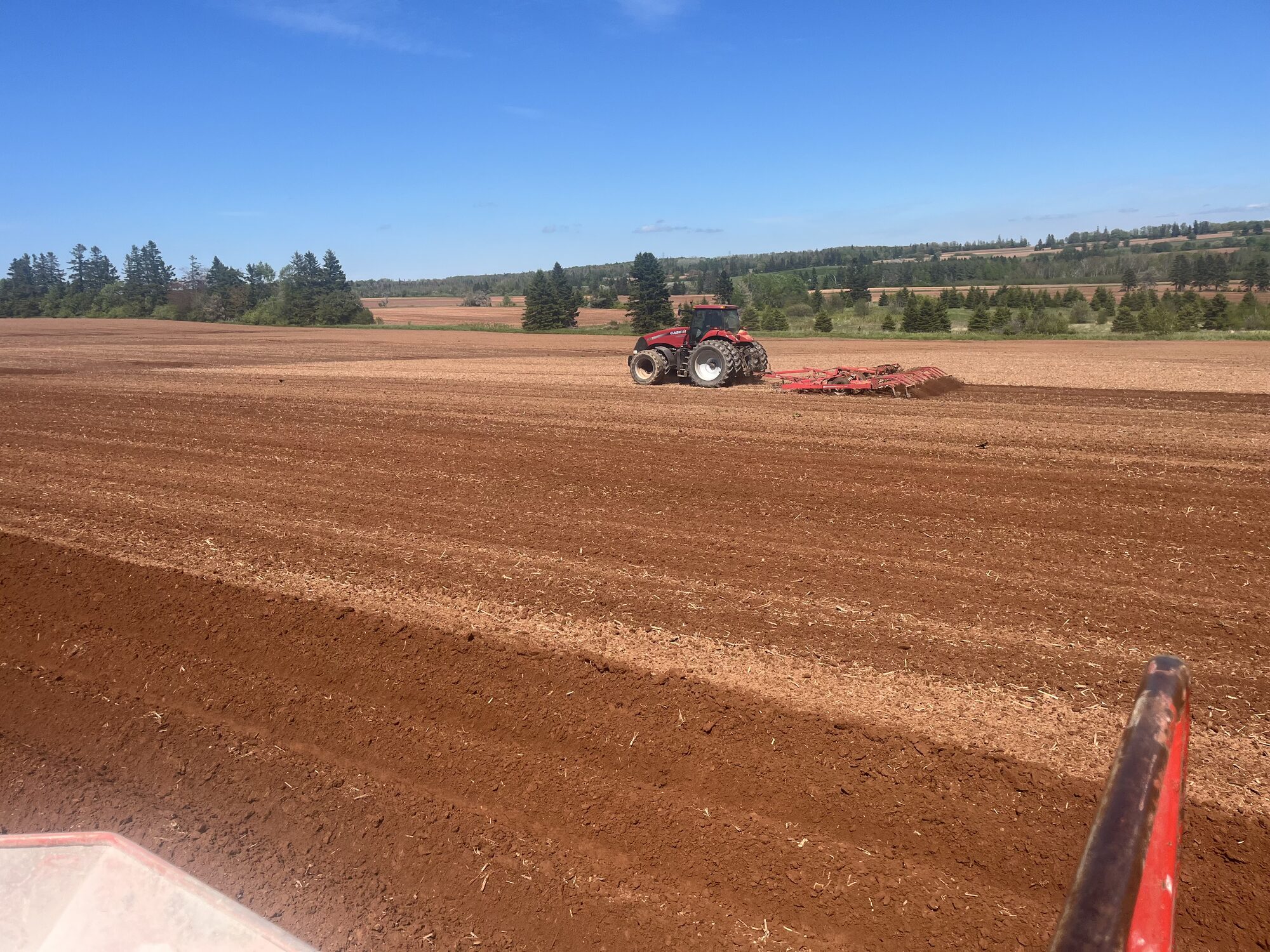 A tractor working the red soil on Prince Edward Island's south shore